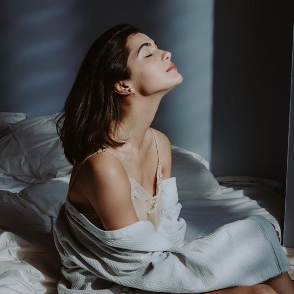 Person in a meditative pose feeling harmony and peace.